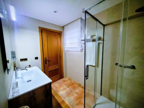 a bathroom with a sink and a glass shower at Can Carbó in Pals