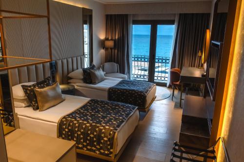 a hotel room with two beds and a balcony at Rocks Hotel & Casino in Kyrenia