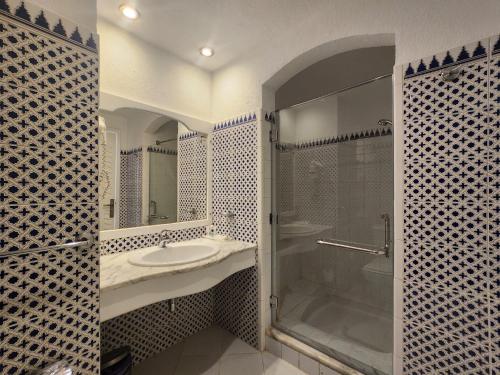 a bathroom with a sink and a shower at MDS Coral Bay Pearl Sea View Resort in Sharm El Sheikh