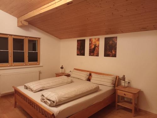 a bedroom with a large bed with two night stands at Fewo zum schwarzen Hirsch in Dalaas