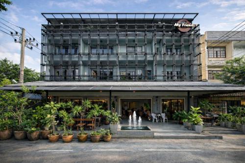 a building with plants in front of it at My Friends Hotel in Trang