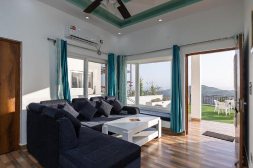 a living room with a couch and a table at The Bougainvillea Retreat in Dehradun