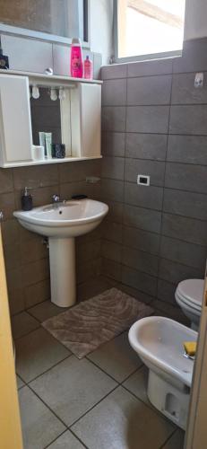 a bathroom with a sink and a toilet at Julias house in Biella