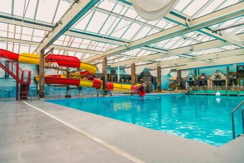 a large swimming pool with a water slide in it at Europarcs Zuiderzee Berkel-4 #363 in Biddinghuizen