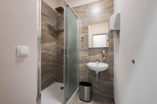 a bathroom with a sink and a shower at ROYAL ROOMS*** in Ljubljana