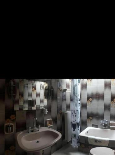 a bathroom with a sink and a toilet at Aegina House in Egina