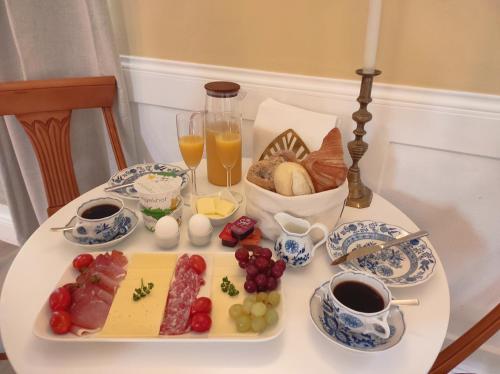 a table with a tray of breakfast foods and drinks at Chateau Suites - Schloss Malberg in Malberg