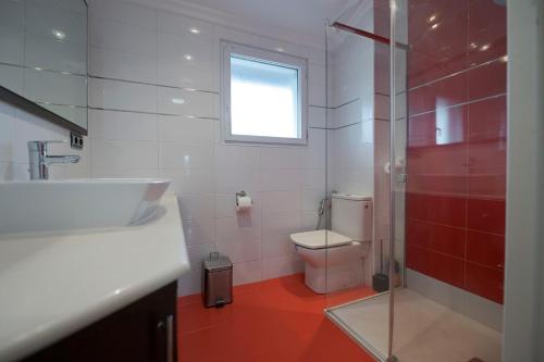 a bathroom with a toilet and a sink and a shower at Villas del Empereur in Hendaye