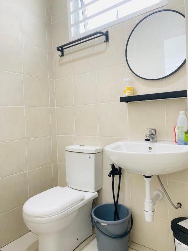 a bathroom with a toilet and a sink at Izans Homestay Sendayan in Seremban