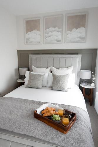a tray of food sitting on top of a bed at Central Cheltenham Luxury Apartment – Edmonstone House in Cheltenham