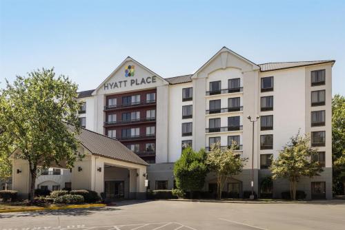 a hotel building with a sign that reads night palace at Hyatt Place Atlanta Airport South in Atlanta