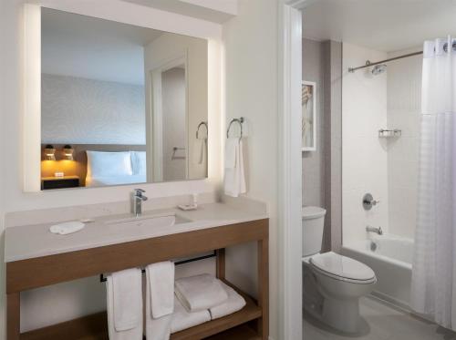 a bathroom with a sink and a toilet and a mirror at Hyatt Place Fort Myers Estero - Newly Renovated in Estero