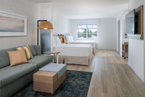 a living room with a couch and a bed at Hyatt Place Fort Myers Estero - Newly Renovated in Estero