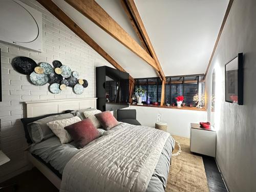 a bedroom with a large bed and a brick wall at Luxury Double Room in Chislehurst