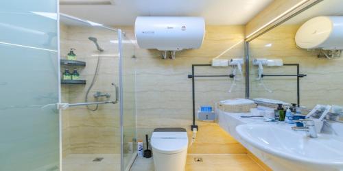 a bathroom with a shower and a toilet and a sink at 上海晶彩酒店式公寓江桥万达店 in Shanghai
