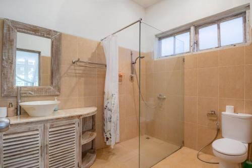 a bathroom with a shower and a toilet and a sink at Villa 3bdrm Sanur 800 m ocean in Sanur