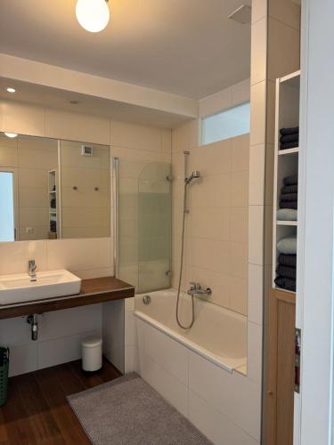 a bathroom with a sink and a tub and a shower at Exceptional house by Lake Geneva in Versoix