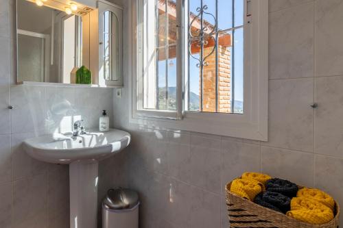 a bathroom with a sink and a mirror at Casa Mira in Cómpeta