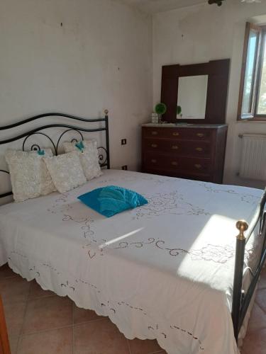 a bedroom with a large bed with a dresser and a mirror at Dimora dei nonni in Poggioferro