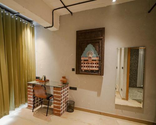 a room with a table and a chair and a window at Local Lok in Varanasi