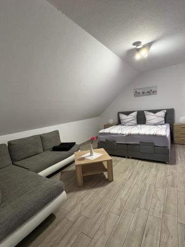 a living room with a bed and a couch at Spreewälder Ferienpension in Lübben