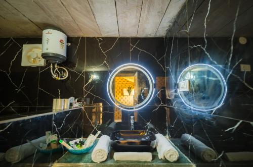 a bathroom with a toilet and a mirror at Jumeria Grand Luxury Desert Resort & Camp in Jaisalmer
