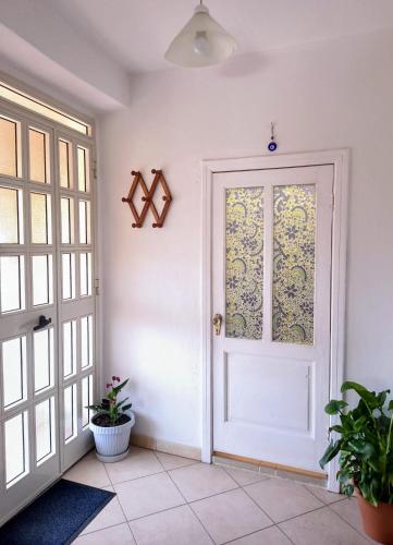 a white door with a window in a room at Tana di Zia Nature, Yourself, Love in Viggianello