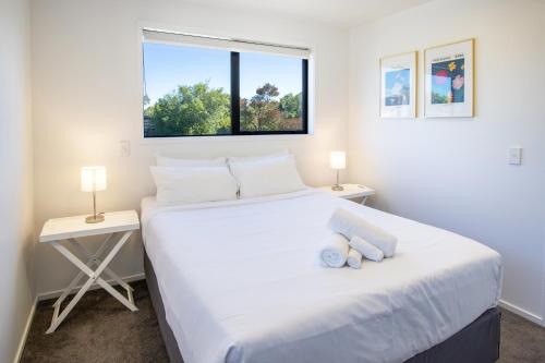a bedroom with two beds and a window at Charming 2-Bedroom Apartment - 2 BR, 1 Bath in Christchurch
