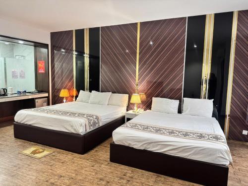 a hotel room with two beds and a mirror at Glory House in An Khê