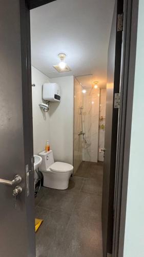 a bathroom with a toilet and a shower at Sky High City View 2BR Corner Condomonium in Pulau Sembakau Kecil