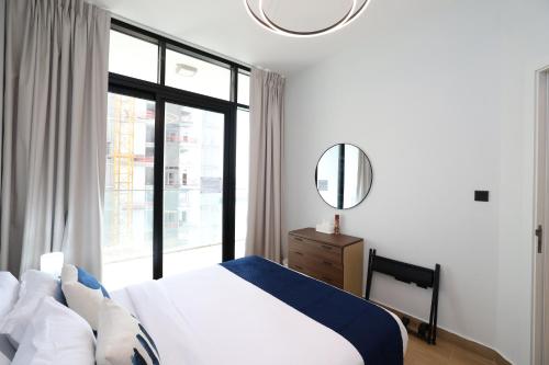 a bedroom with a bed and a large window at Maryah Island 1 Bed Junior Next to Cleveland Hospital by Central Stay in Abu Dhabi