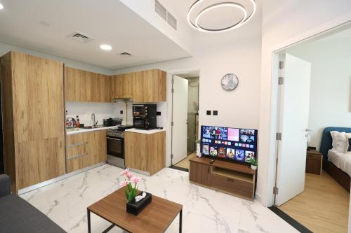 a living room with a couch and a kitchen at Maryah Island 1 Bed Junior Next to Cleveland Hospital by Central Stay in Abu Dhabi