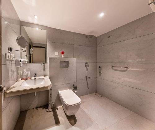 a bathroom with a toilet and a sink at Lords Eco Inn Dahej in Dahej