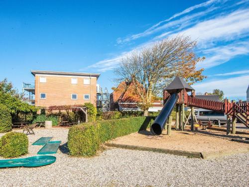 a playground with a slide in a park at 4 person holiday home on a holiday park in Hejls in Hejls