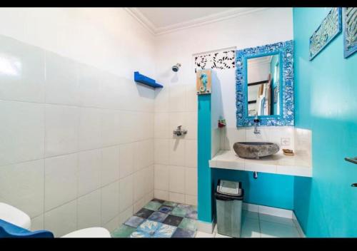 a bathroom with a sink and a mirror at Isin Gumi Homestay in Amed