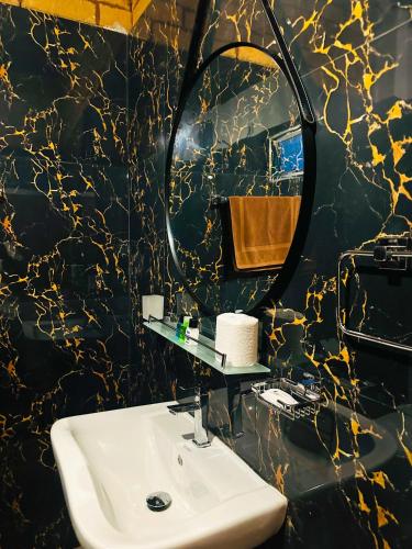 a bathroom with a sink and a mirror at Sigiriya Dream Inn in Sigiriya