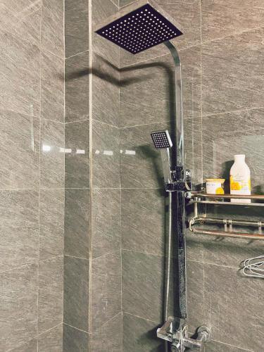 a shower with a glass door in a bathroom at Êm Tiny in Hai Phong