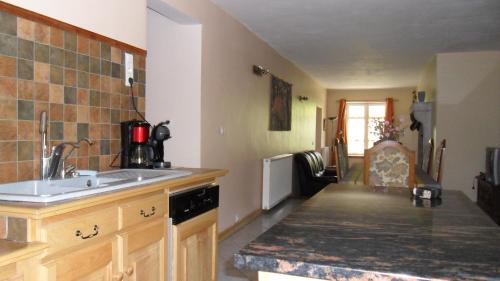 a kitchen with a sink and a counter top at Gîte de Très Bayard in Saint-Claude