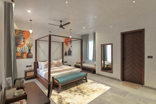 a bedroom with a canopy bed and a mirror at Kaizen Eirene Luxe Villas, Udaipur in Nāi