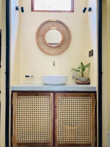 a bathroom with a sink and a mirror on a counter at Layday Surf Ahangama in Ahangama
