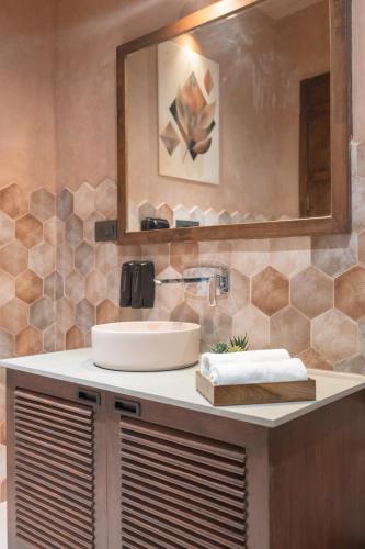 a bathroom with a sink and a mirror at Kaizen Eirene Luxe Villas, Udaipur in Nāi