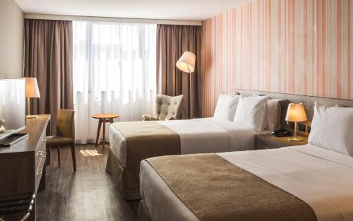 En eller flere senge i et værelse på Frontier Hotel Rivera