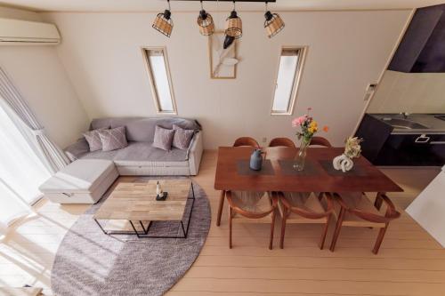 a living room with a table and a couch at ｾ-ﾇeast in Takasaki