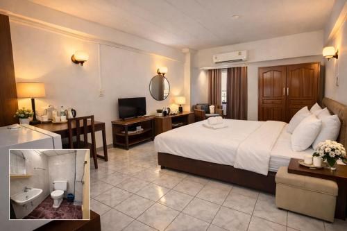 a hotel room with a large bed and a bathroom at โรงแรมวินบางนา Win Bangna Hotel in Bangna