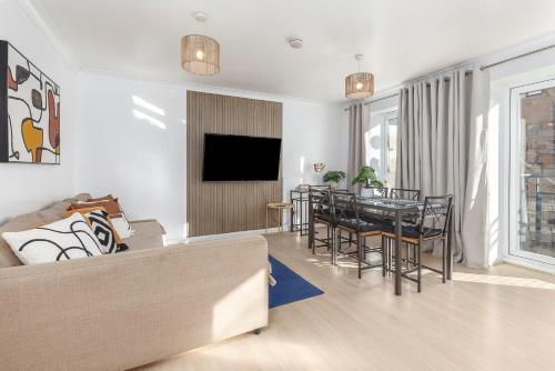 a living room with a couch and a table at Cosy 2 BDR flat 5 min to ExCel free Car Parking in London