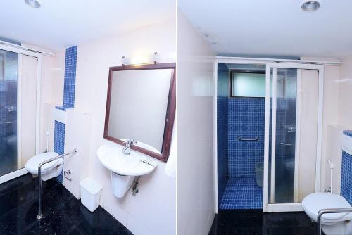 a bathroom with a sink and a toilet and a shower at Manor Backwater Resort in Kumarakom