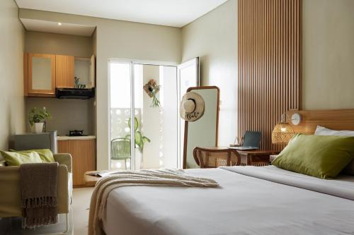 a bedroom with a bed and a living room at Deva Bali Apartement in Kerobokan