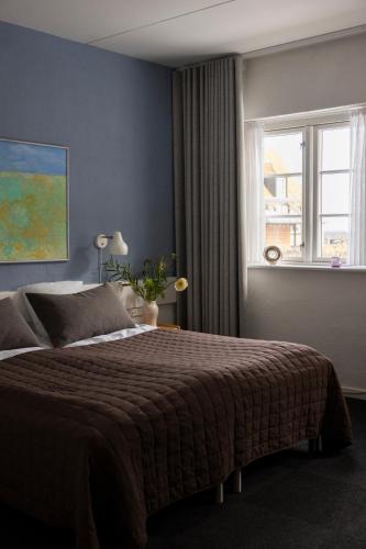 En eller flere senge i et værelse på Hotel Siemsens Gaard