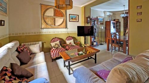 a living room with two couches and a table at La Vieja Parra in La Puerta de Segura