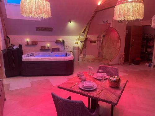 a living room with a table and a tub at Romantic Love - So Lovely in Bailleval